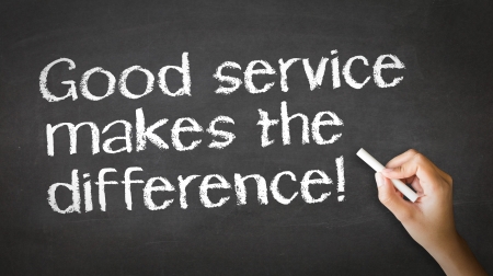 A person drawing and pointing at a Good Service makes the difference Chalk Illustrationの写真素材