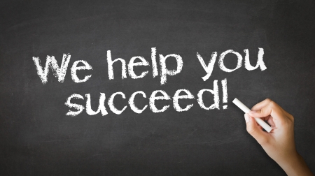 A person drawing and pointing at a We help you succeed Chalk Illustrationの写真素材