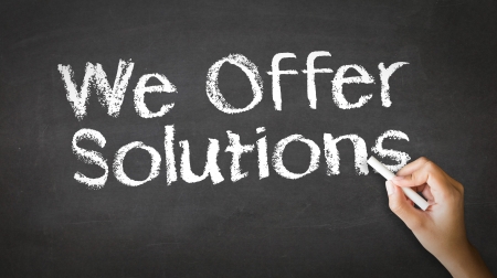 A person drawing and pointing at a We offer Solutions Chalk Illustrationの写真素材