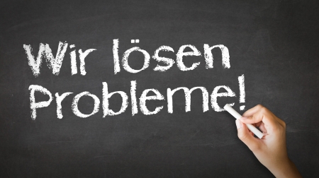 A person drawing and pointing at a We Solve Problems Chalk Illustrationの写真素材