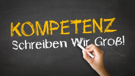 A person drawing and pointing at a Competence Slogan Chalk Illustrationの写真素材