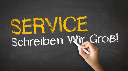 A person drawing and pointing at a Service Slogan Chalk Illustrationの写真素材