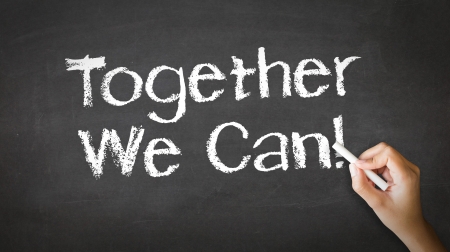 A person drawing and pointing at a Together We Can Chalk Illustrationの写真素材