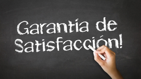 A person drawing and pointing at a Satisfaction garantied Chalk Illustrationの写真素材