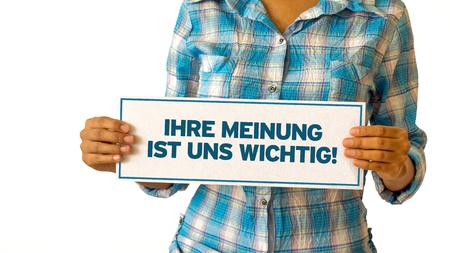 A woman holding a Your opinion matters sign.の写真素材