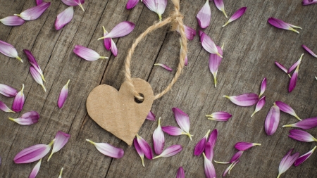 A paper heart with string on wooden backgroundの写真素材