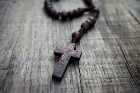 A  rosary with beads on wooden textured background. の写真素材