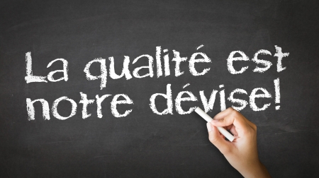 A person drawing and pointing at a We Focus On Quality Chalk Illustrationの写真素材