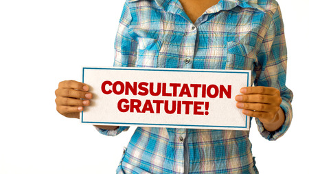 A woman holding a Free Consultation sign.の写真素材