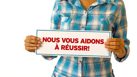 A woman holding a We Help You Succeed sign.の写真素材