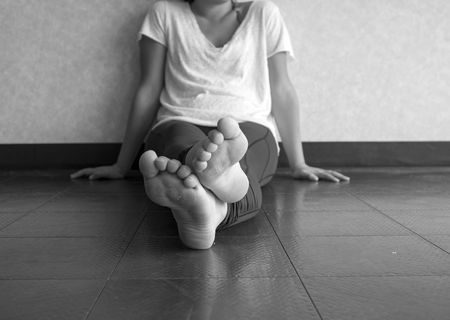 Black and white version of Young woman doing yoga taking a break sitting cross leggedの写真素材