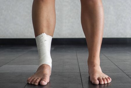 Ankle tape job on an athleteâs ankleの写真素材