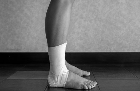 Black and white version of Side view of an Ankle tape job on an athleteâs ankleの写真素材