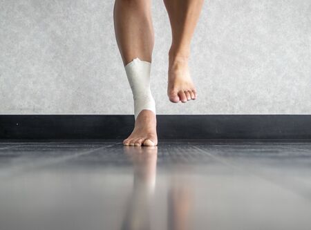 Athlete balancing to regain proprioception on sprained ankleの写真素材