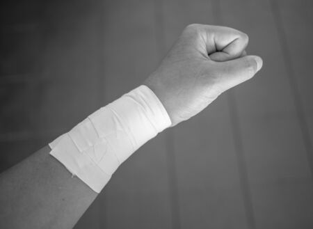 Black and white version of Making a fist with a wrist tape jobの写真素材