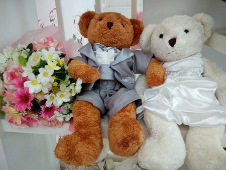 Wedding couple of teddy bears are very cute with beautiful flowers bouquet.の写真素材