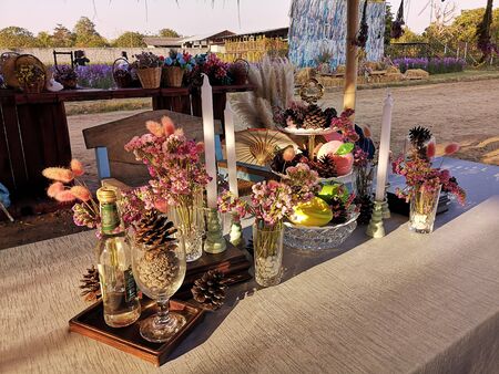 Floral decorations, candlesticks, glassware are set on the table to take pictures.の写真素材