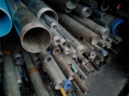 Metal pipes of various types and sizes in soft focus, closeup.の写真素材