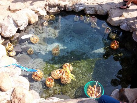 The basket of Boil eggs in mineral water of natural hot spring at Chae Son National Park  Lampang  Thailand.の写真素材