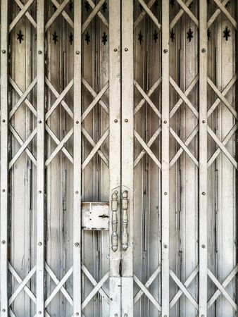 The old style steel door closed has been used for a long time.の写真素材