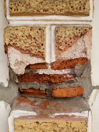 Old cement posts that had been broken over time to see the red bricks inside.の写真素材