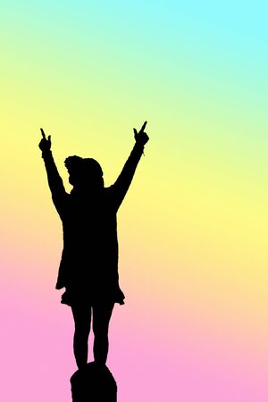 portrait silhouette of woman raise her hand to the sky in pastel color background image with clipping pathの写真素材