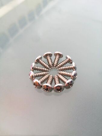 stainless self-tapping screws in closeup on gray backgroundの写真素材