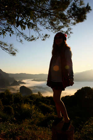 Portrait silhouette woman standing in front The scene of the sunrise in the mountainsのeditorial素材