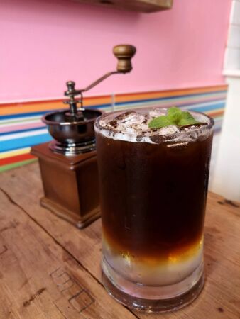 Black coffee, America, iced on the wooden table, the background is blurred.の写真素材