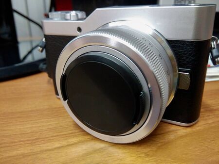 A camera placed on a wooden tableの写真素材
