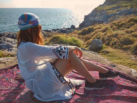 The woman has a beautiful veil, looking back at the sea.の写真素材