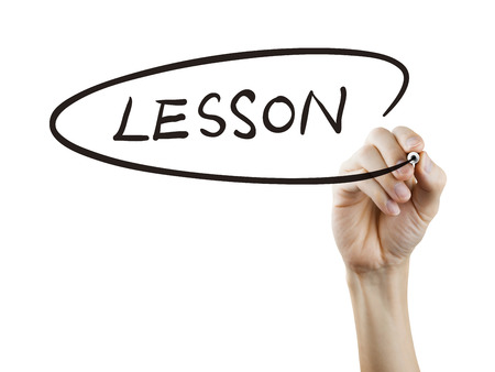 lesson word written by hand on a transparent boardの写真素材