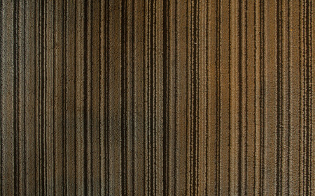 Warm carpet background, close up look of brown striped carpet