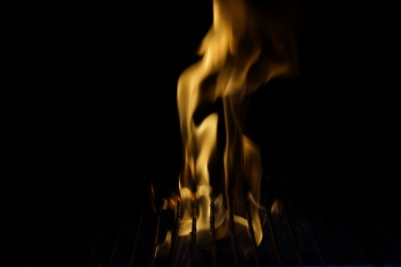Flames in a barbecue. They have a yellow color. Front view, in outside and without character.の写真素材