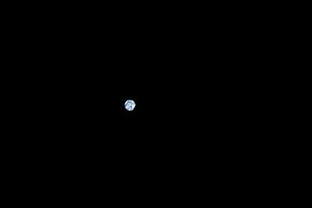 The moon is round and brilliant. The sky is dark, the moon strongly shines.