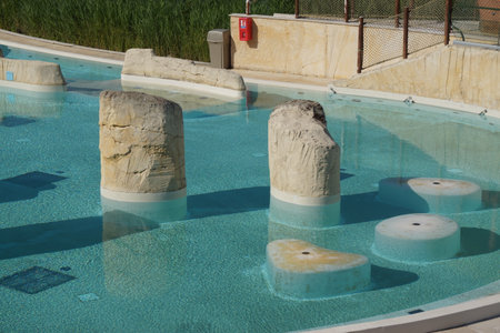Beneath a radiant sky, a large public swimming pool stretches out. France.の写真素材
