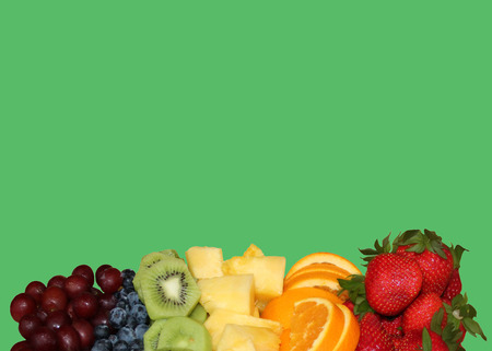 Colorful fruit laid out nicely on a green backgroundの写真素材