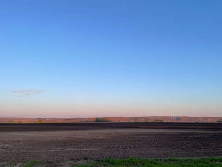 plowed field and blue sky.