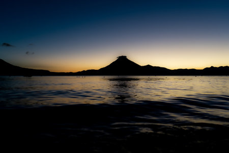 Sunset in the sea with a silhouette of Mount Vesuviusの写真素材