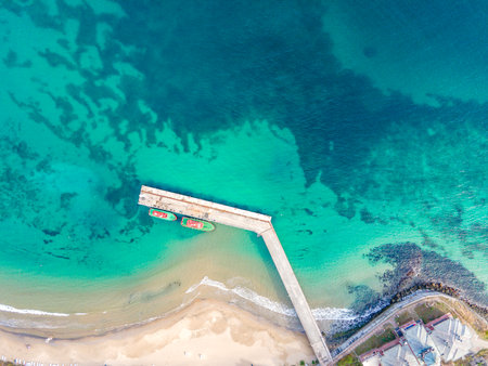 Wooden dock and two boats with blue sea. Aerial drone view of beautiful sea and beach. Summer holiday background view.の写真素材