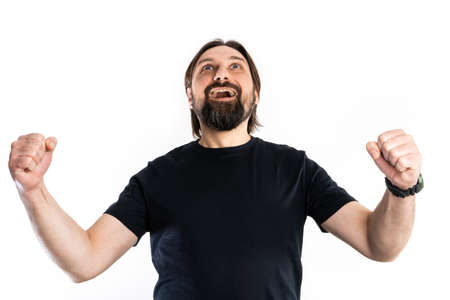 The man dressed in a black shirt poses in a photo studio.