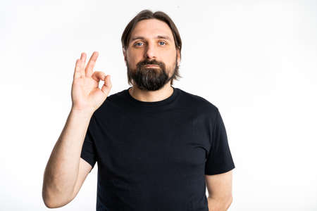 The man dressed in a black shirt poses in a photo studio.の写真素材