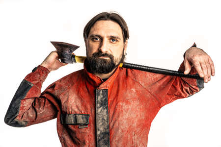 The man poses with an ax in a photo studio.の写真素材