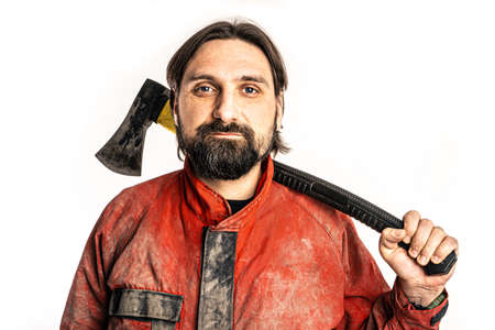 The man poses with an ax in a photo studio.の写真素材