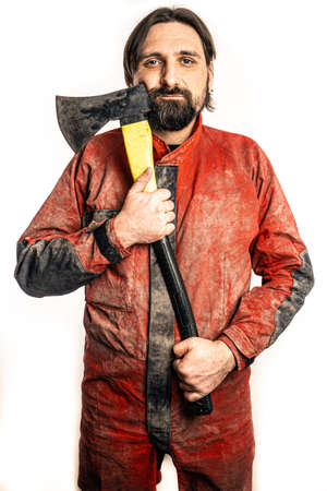 The man poses with an ax in a photo studio.の写真素材