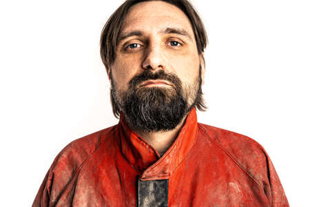 The man wearing a red overalls poses in a photo studio.の写真素材