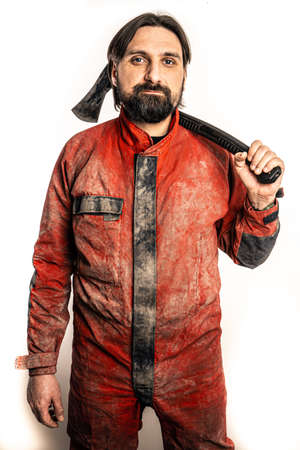The man poses with an ax in a photo studio.の写真素材