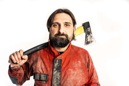 The man poses with an ax in a photo studio.の写真素材
