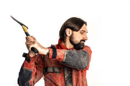 The man poses with an ax in a photo studio.の写真素材