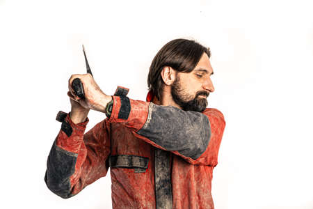 The man poses with an ax in a photo studio.の写真素材